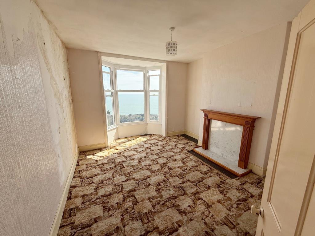 Lot: 163 - FOUR-BEDROOM HOUSE FOR IMPROVEMENT WITH STUNNING SEA VIEWS AND REAR VEHICULAR ACCESS - Looking into a first floor bedroom